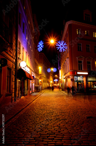 Narrow street in old Riga by night in Christmas time