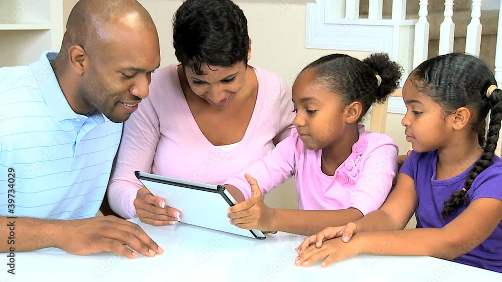 Young Ethnic Family Using Wireless Tablet Young Ethnic Family Using Wireless Tablet