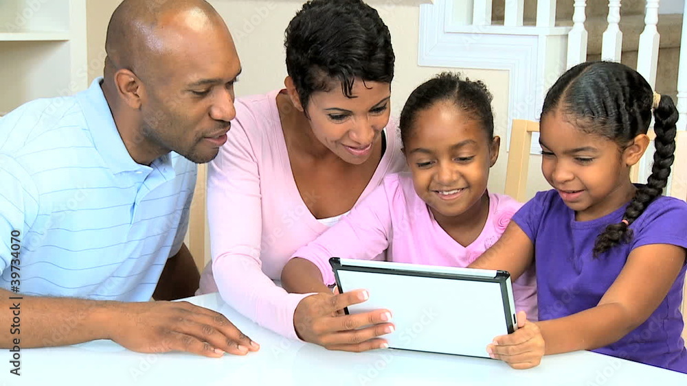 Young Ethnic Family Using Wireless Tablet Young Ethnic Family Using Wireless Tablet