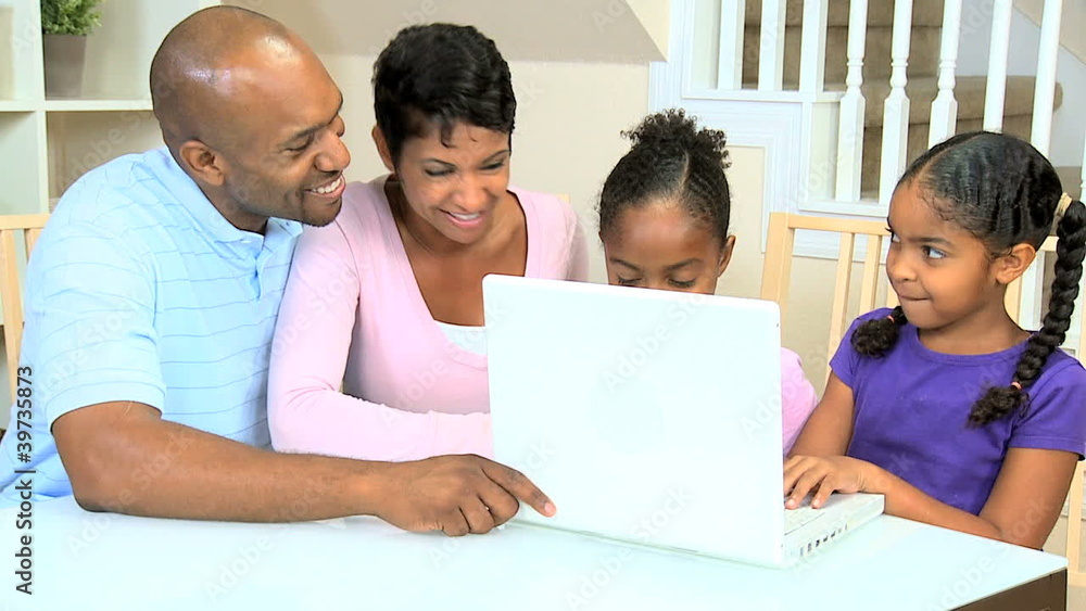 Ethnic Parents Watching Daughters Using Laptop Ethnic Parents Watching Daughters Using Laptop
