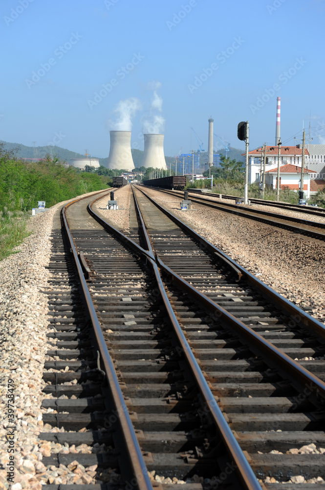 Fototapeta premium Industrial landscape with chimneys and train.