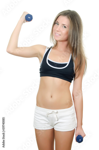 The girl does exercises with dumbbells