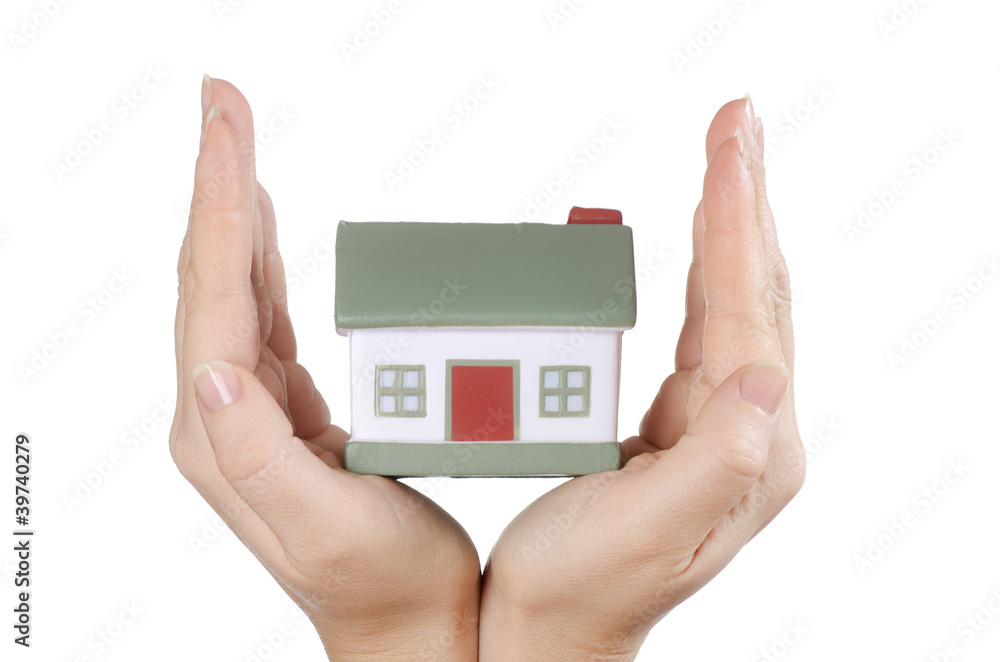 The model house in female hands on white The model house in female hands on white