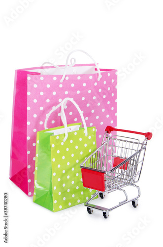 The shopping cart and bags isolated on white