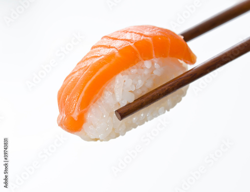 Chopsticks holding sushi roll