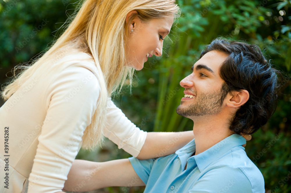 Portrait of love couple embracing outdoor in park