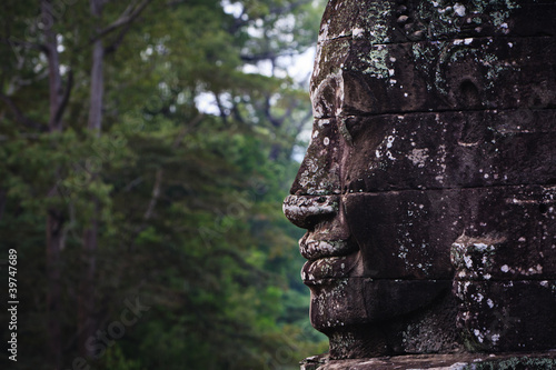 Stone face and jungle at Angkor Wat © Pete Niesen Photo