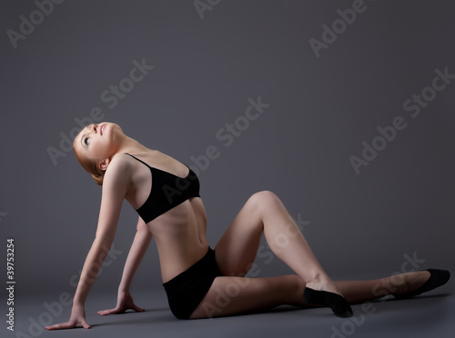 young gymnast girl in black top look at light