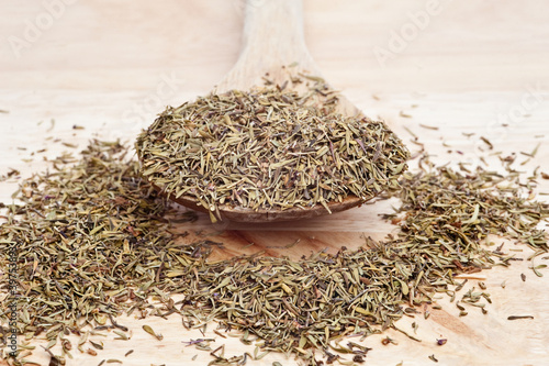 Thyme on wooden serving spoon with selective focus