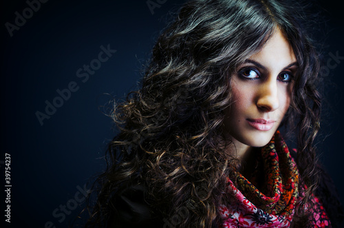 Portrait of a beautiful lady with long curly hair