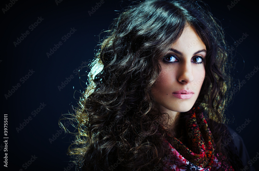 Portrait of a beautiful lady with long curly hair