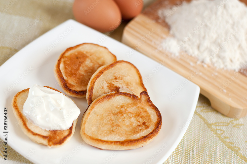 Home pancakes with sour cream, flour and eggs Home pancakes with sour cream, flour and eggs