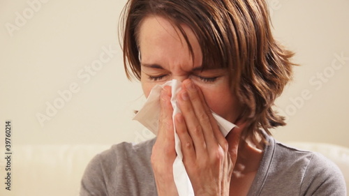 Sneezing woman having a cold. photo