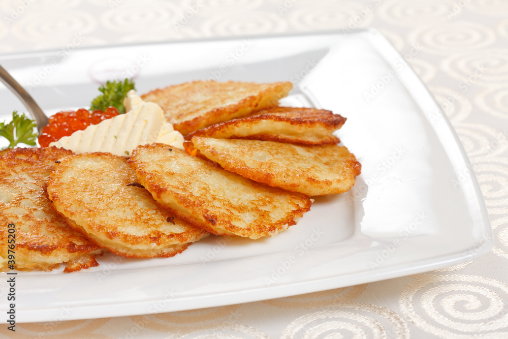 fried potatoes pancakes with caviar