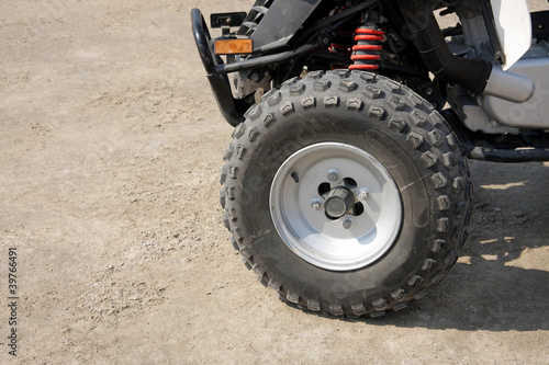 Close view of the treads and grooves on front wheel of ATV