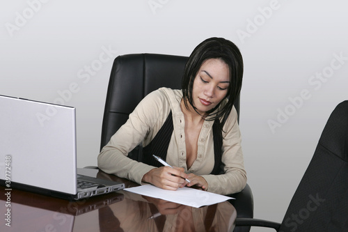 brunette working at her office desk photo