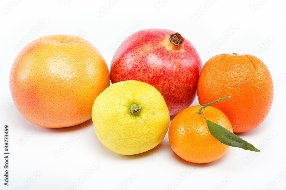 pomegranates and citrus fruits isolated on a white background. pomegranates and citrus fruits isolated on a white background.