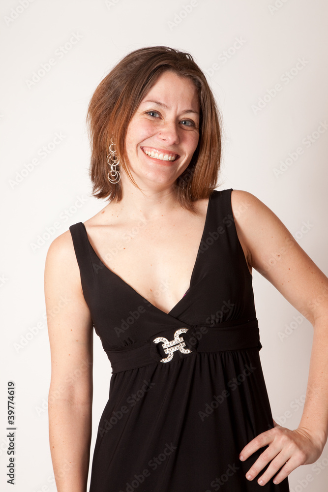 Pretty brunette smiling at the camera with hand on hip Pretty brunette smiling at the camera with hand on hip