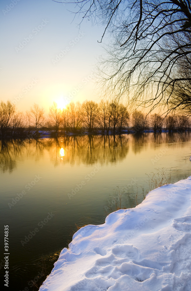 Sunset over frozen river