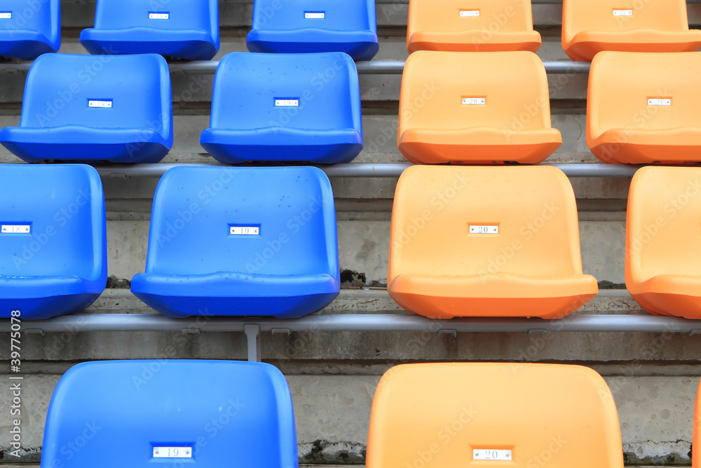 Fototapeta premium plastic, yellow and blue, new chairs in stadium.