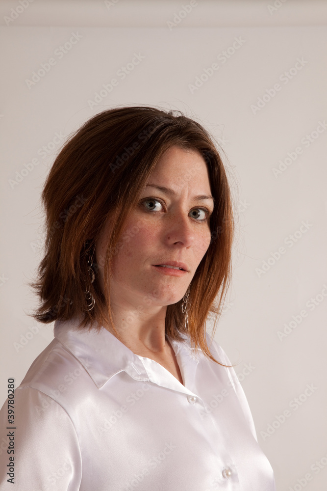 Woman wearing white silk shirt, looking at camera