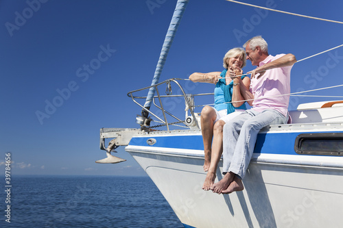 Happy Senior Couple Sitting On a Sail Boat