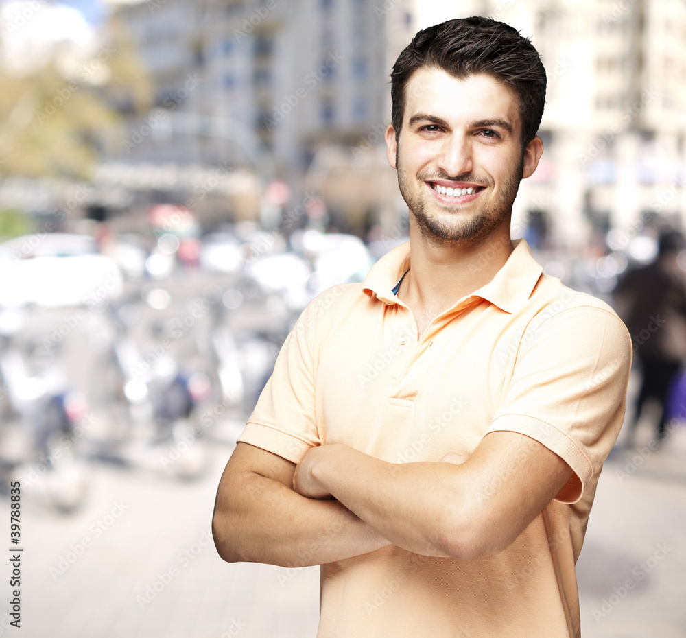 Fototapeta premium portrait of a comely young man smiling at a crowded street