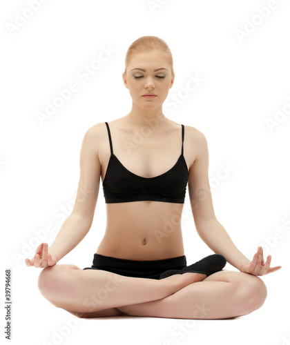 Cute blond girl sit in yoga lotos asana pose