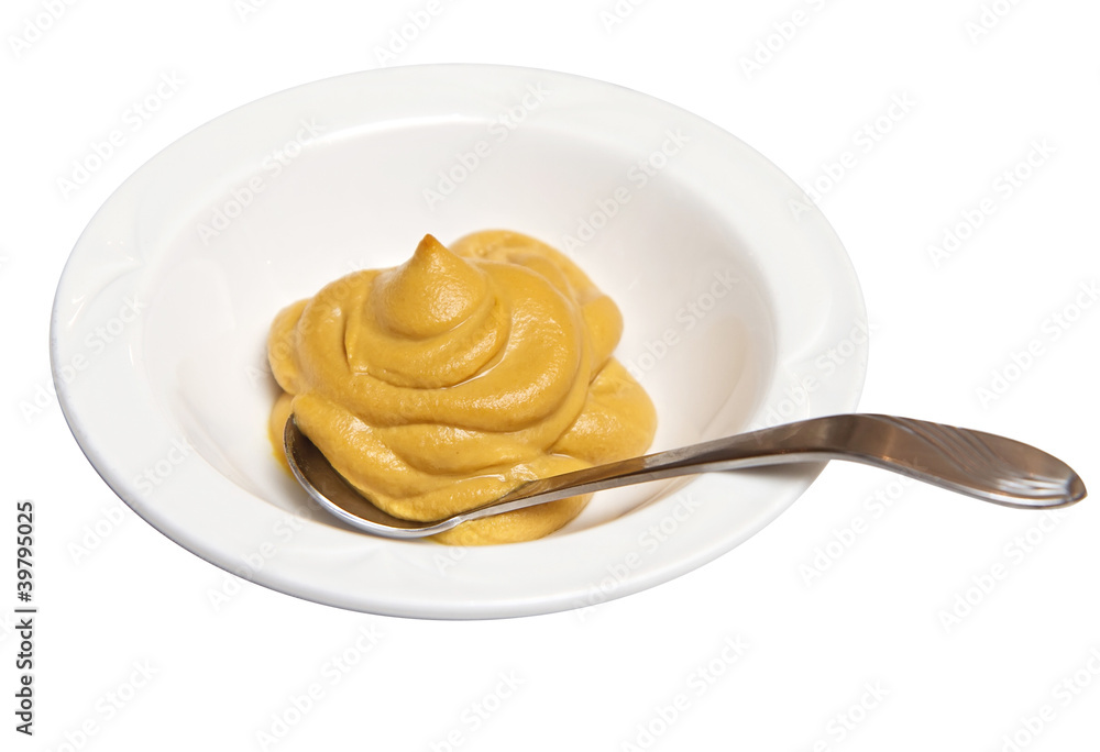mustard in a ramekin with a spoon isolated against white mustard in a ramekin with a spoon isolated against white