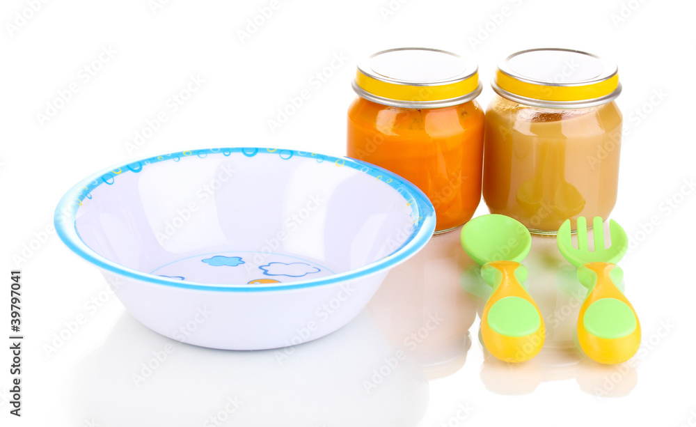Jars of baby puree with plate, spoon and fork isolated on white Jars of baby puree with plate, spoon and fork isolated on white