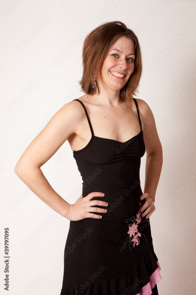 woman in black dress smiling at the camera woman in black dress smiling at the camera