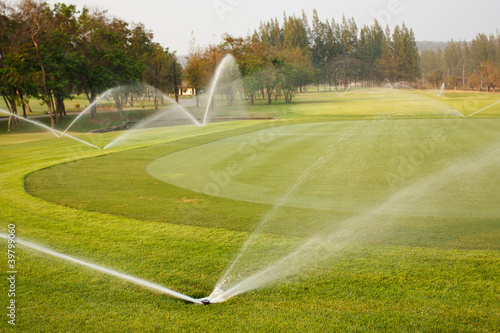 Watering in golf course photo