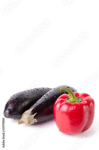 Two eggplants and red bell pepper, isolated over white