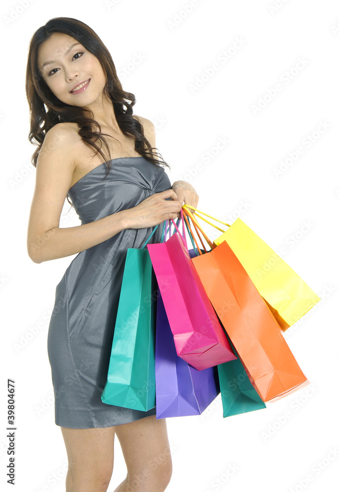 Beautiful stylish woman holding shopping bags in both hands Beautiful stylish woman holding shopping bags in both hands