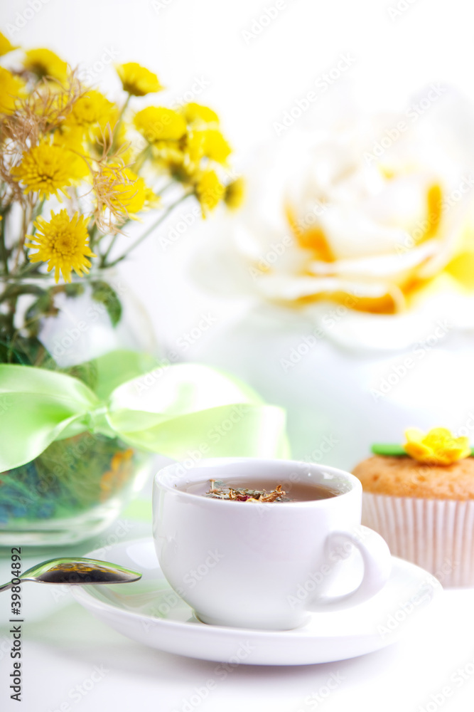 breakfest with tea, cake and yellow flowers