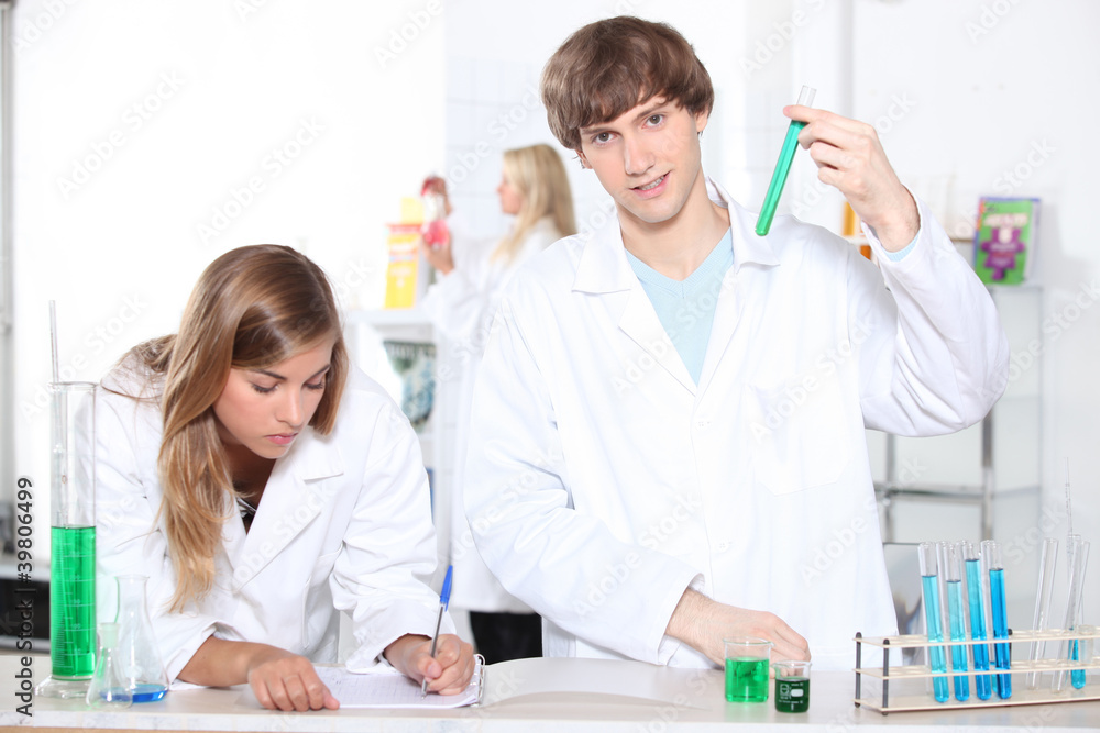 Students in a chemistry class with test tubes Students in a chemistry class with test tubes