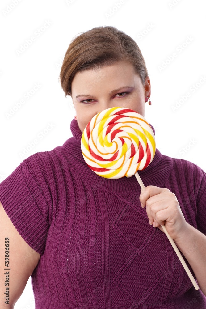 Portrait of plump woman with huge lollipop