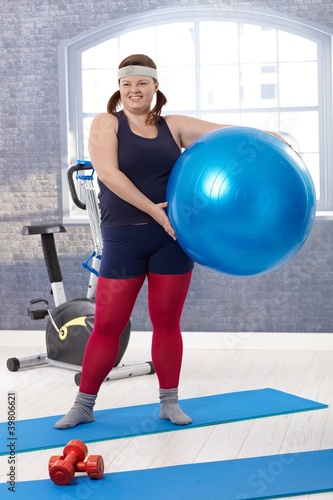 Happy woman with fit ball