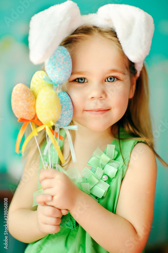Sticker sweet little girl dressed in Easter bunny ears holding colorfull