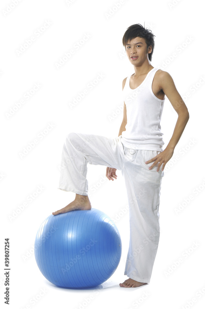 Portrait of confident young man with exercise ball Portrait of confident young man with exercise ball