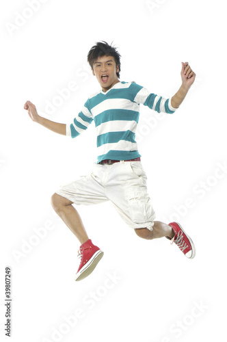 Young happy man jumping in the air