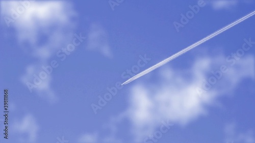 jet airplane with contrails on blue sky