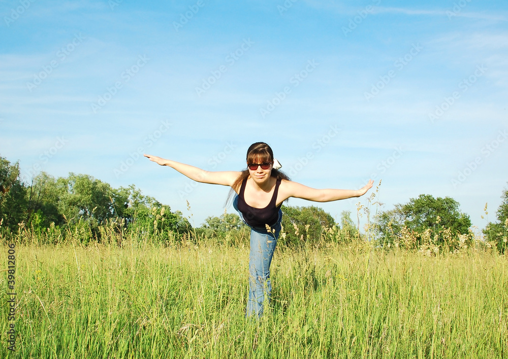 Young woman doing fitness exercises on green meadow Young woman doing fitness exercises on green meadow