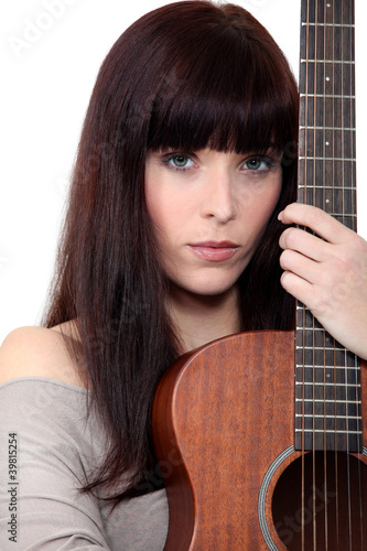 Woman holding acoustic guitar