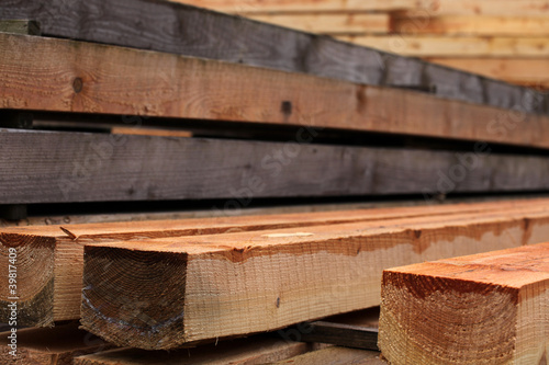 Timber stacked and the sawmill