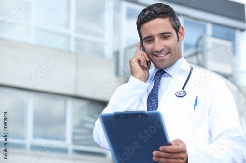 Young doctor stood outside hospital photo