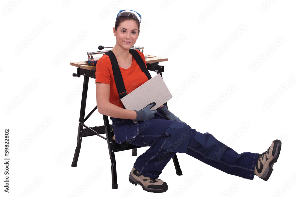 Woman cutting tiles Woman cutting tiles