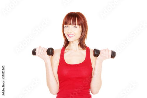 Attractive readhead female lifting weights