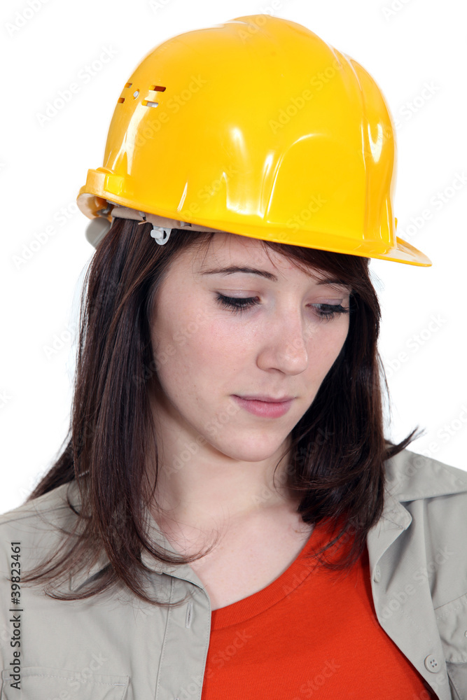 A sad female construction worker. A sad female construction worker.