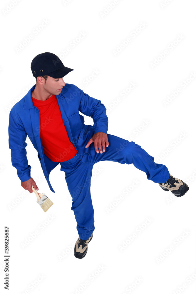 A male painter kicking. A male painter kicking.